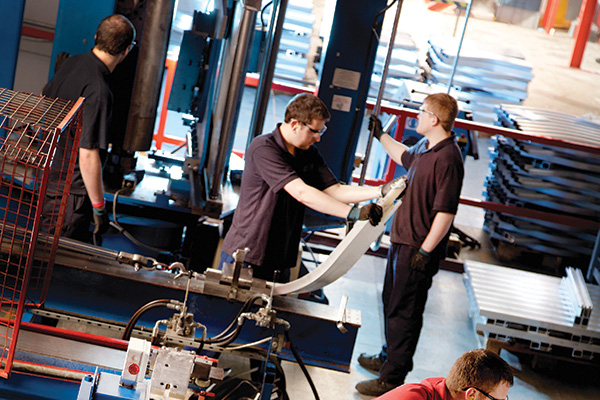 stairlift technicians assembling stairlifts in factory